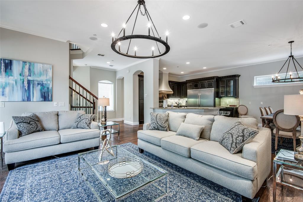 a living room with furniture kitchen and a chandelier