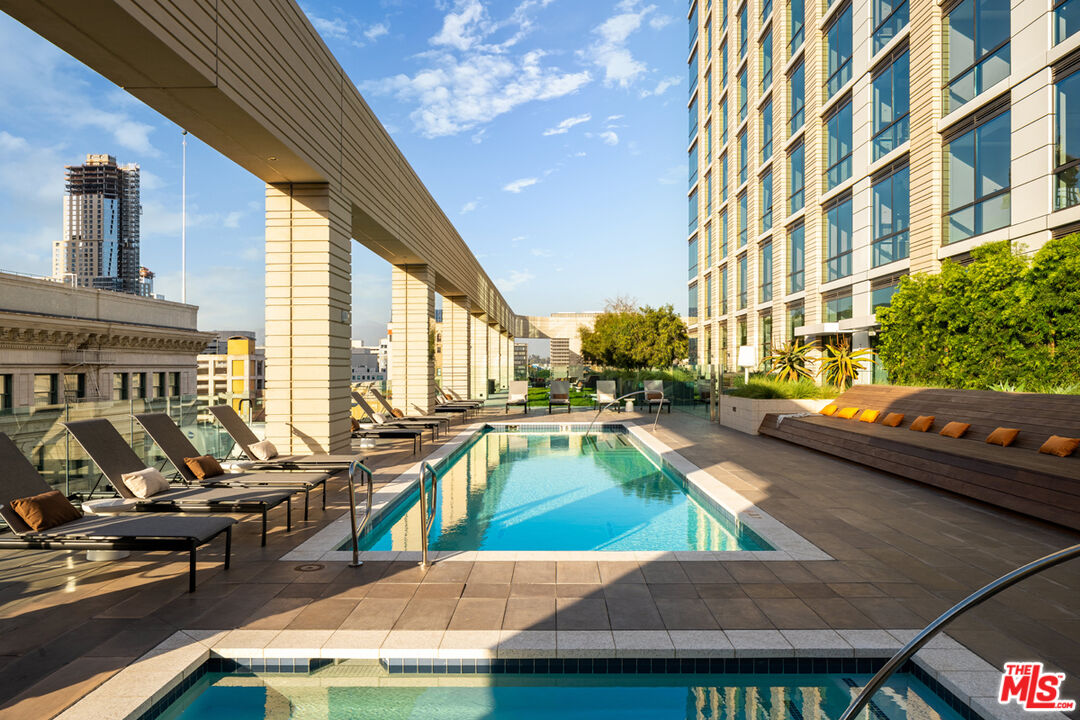 a view of a swimming pool with outdoor seating