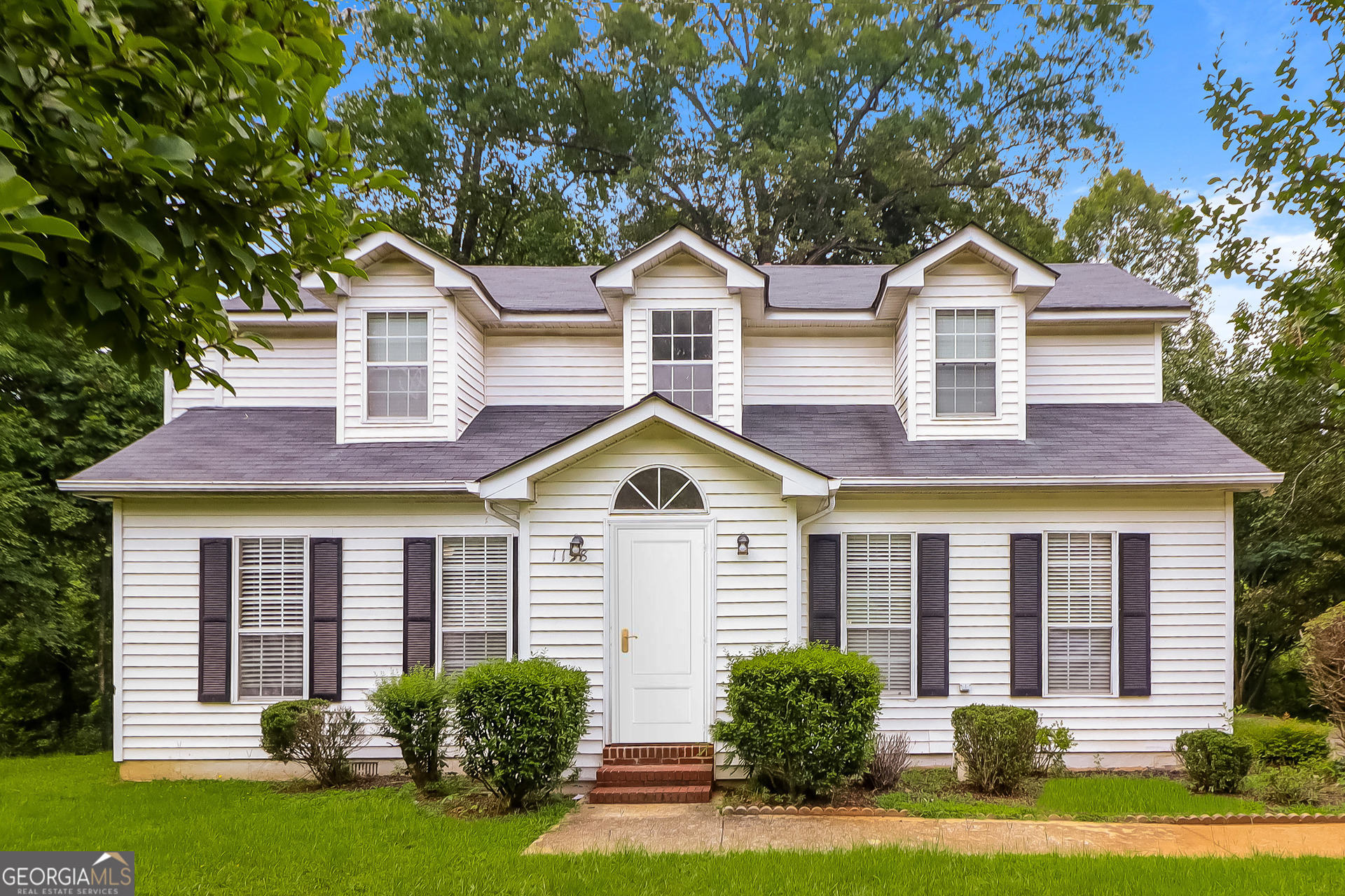 a front view of a house with a yard