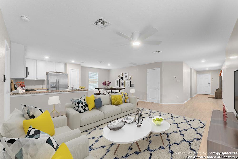 a living room with furniture and kitchen view