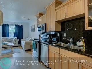 a kitchen with stainless steel appliances granite countertop a sink and cabinets