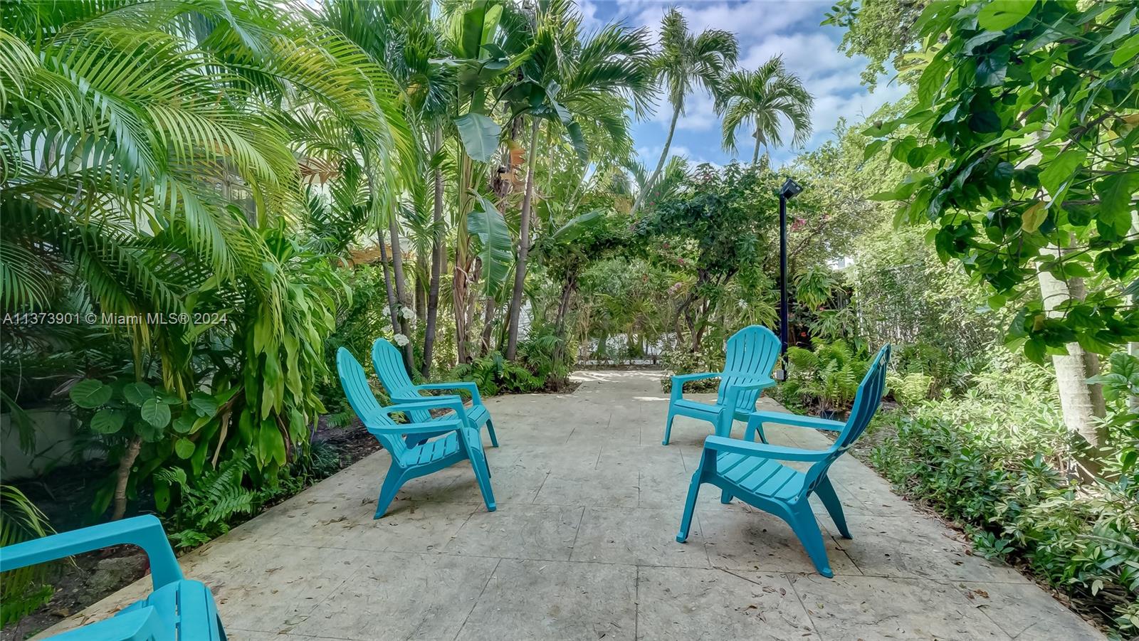 a garden with a bench and some trees