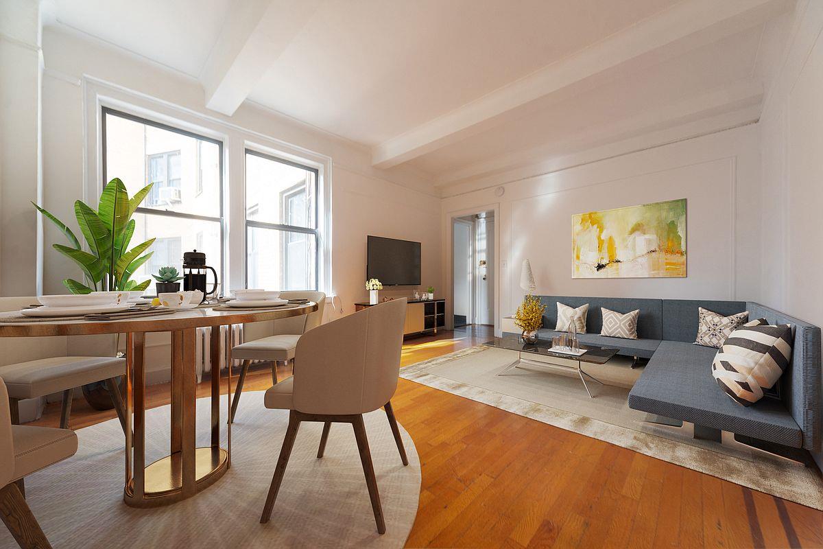 a living room with furniture a window and a flat screen tv