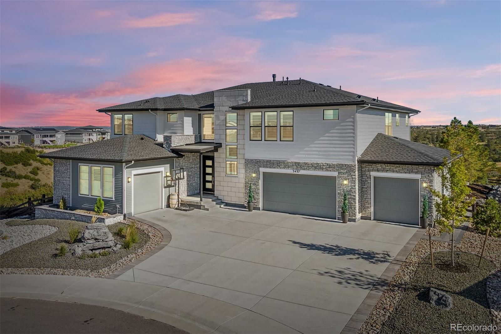 a front view of a house with yard and parking space