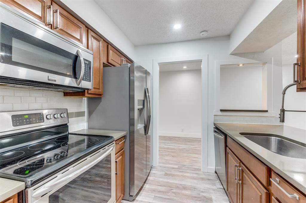 a kitchen with a sink and stainless steel appliances