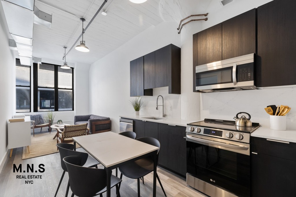 a kitchen with a stove a sink and a microwave