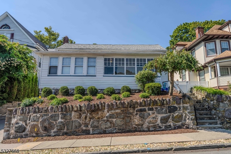 a front view of a house with garden