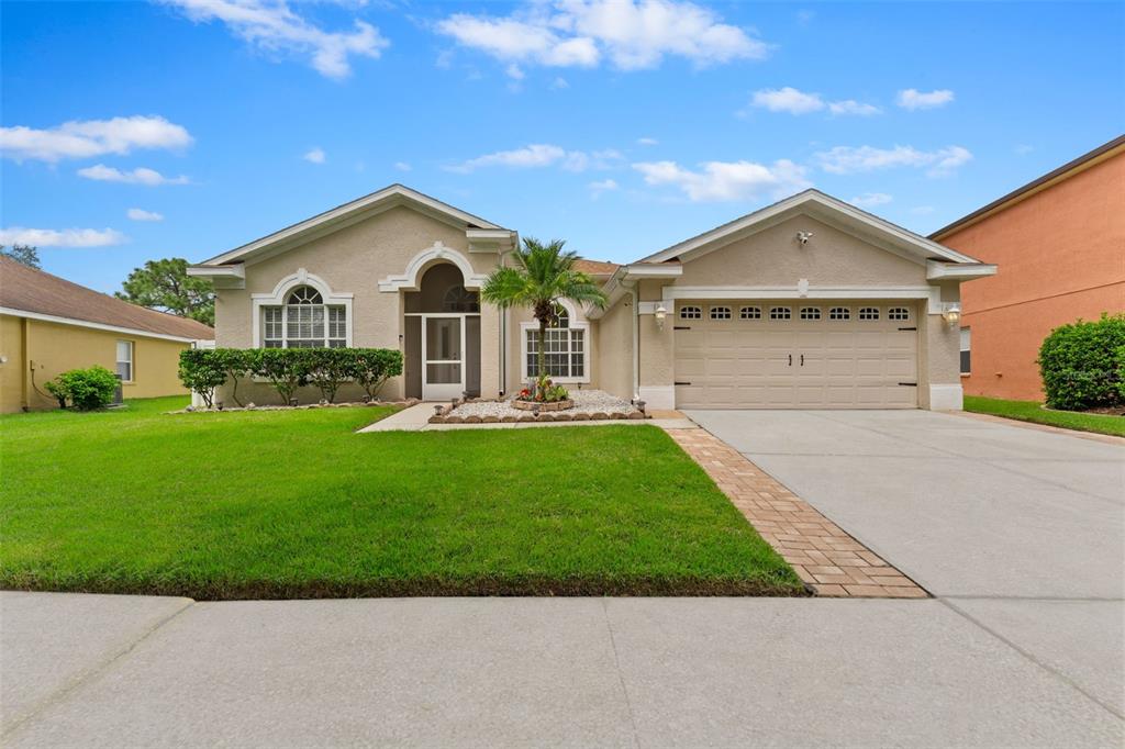 a front view of a house with a yard and garage