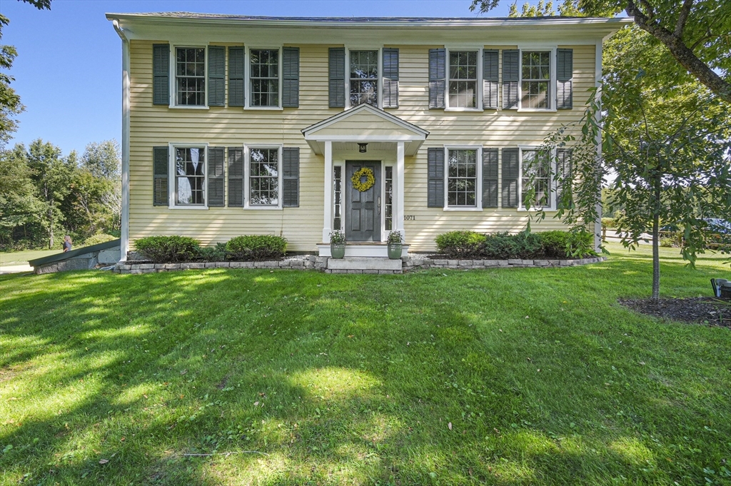 a front view of a house with a yard