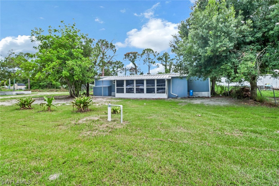 a view of a house with a backyard and a patio