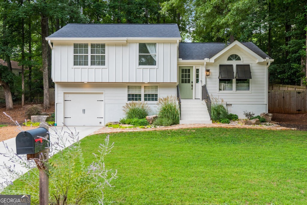 a front view of a house with a yard and garage