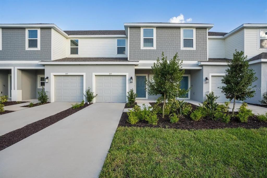 a front view of house with yard and green space