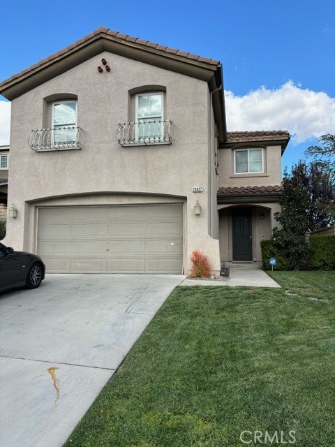 a view of a house with a yard and garage