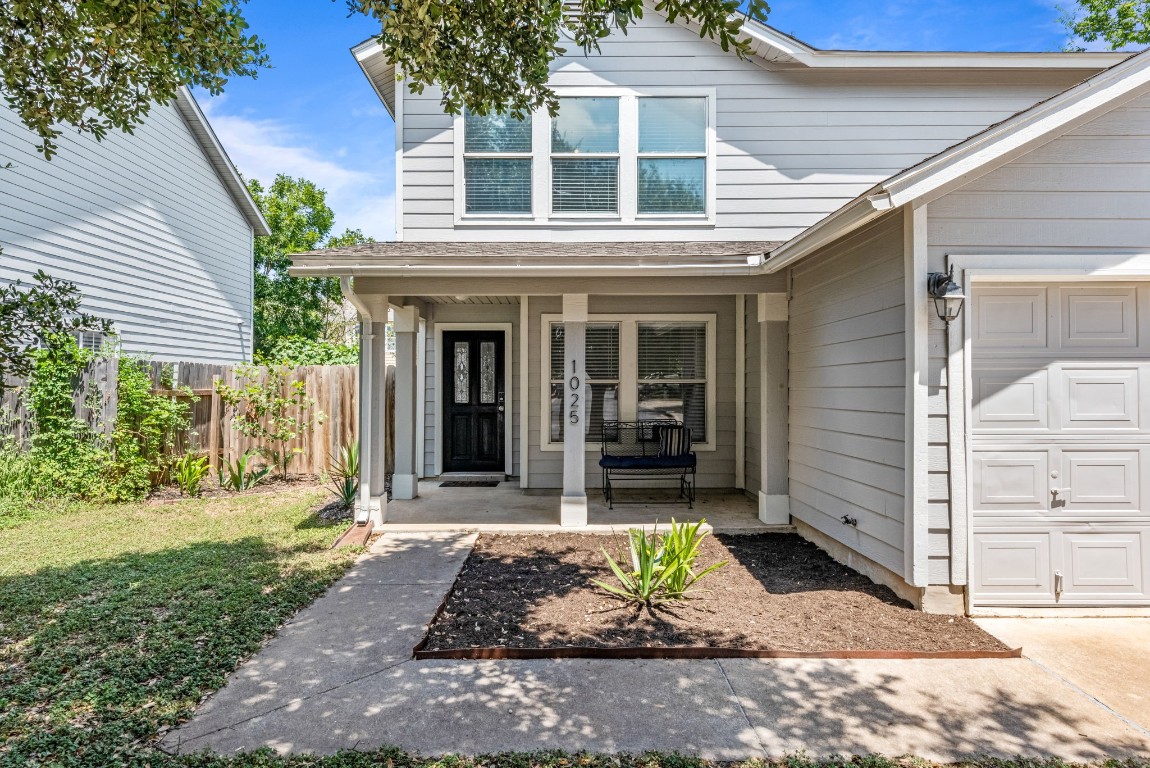 The front porch is a great spot for greeting guests or relaxing in the shade on a sunny day.