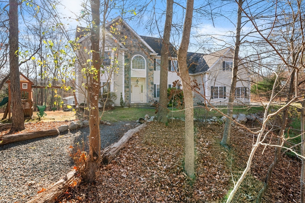 a view of a house with a yard and pathway