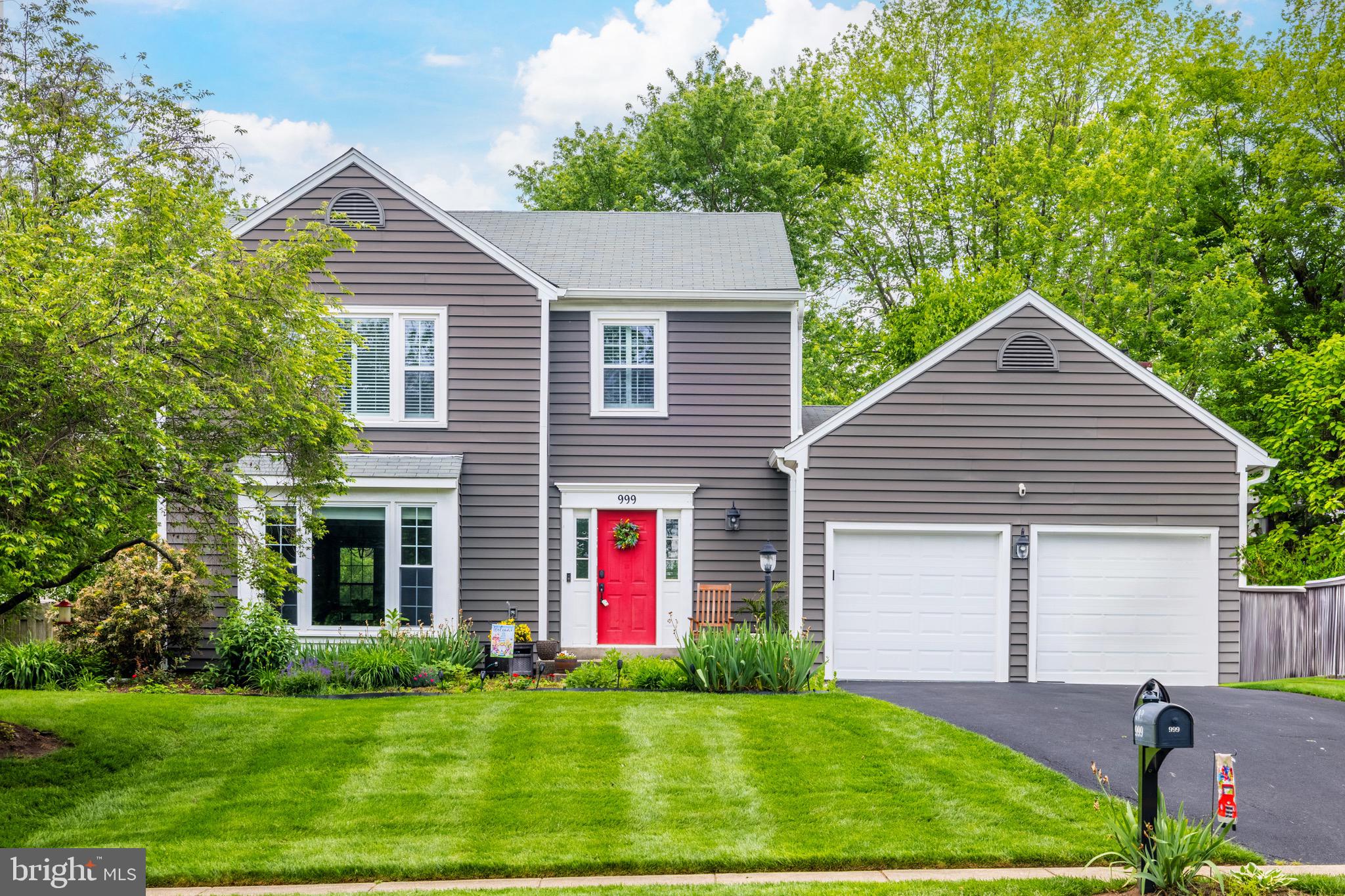 a front view of house with yard and green space