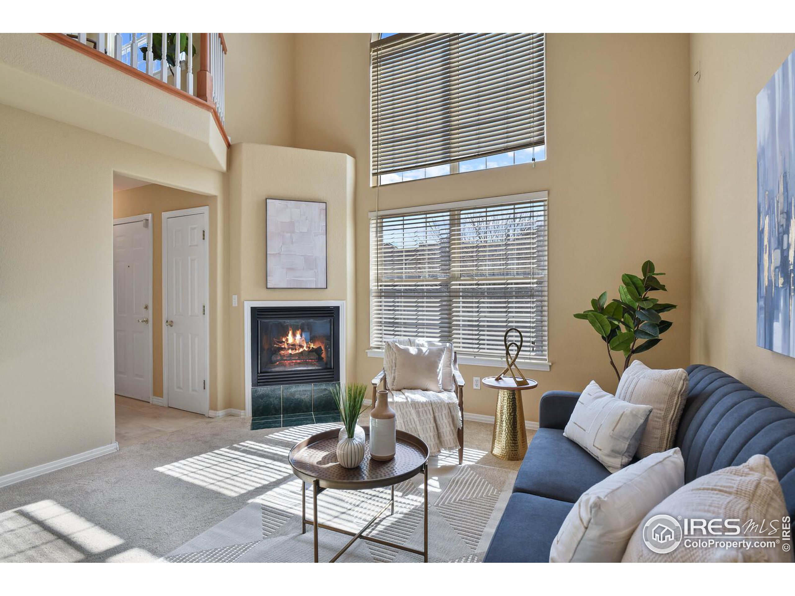 a living room with furniture a window and a fireplace