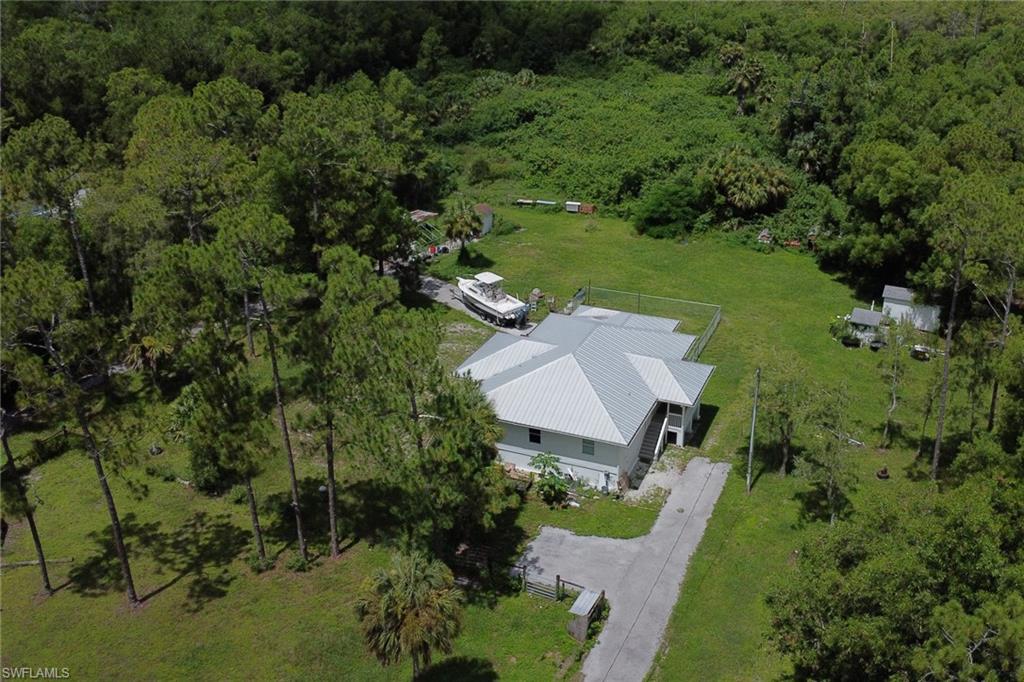 an aerial view of a house with yard