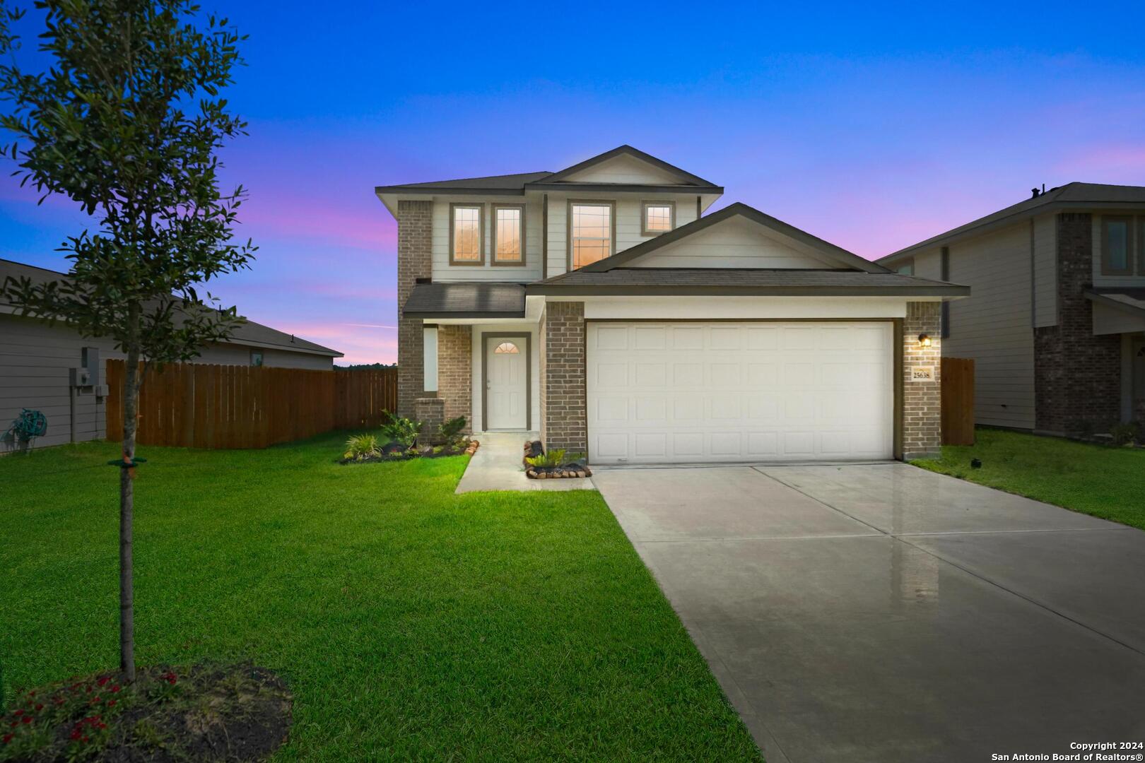 a front view of a house with a yard and garage