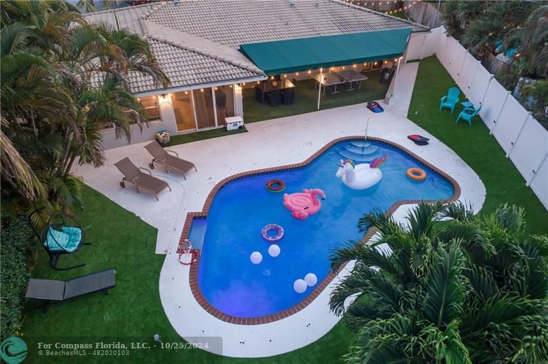 an aerial view of a house roof deck with chairs and a fire pit