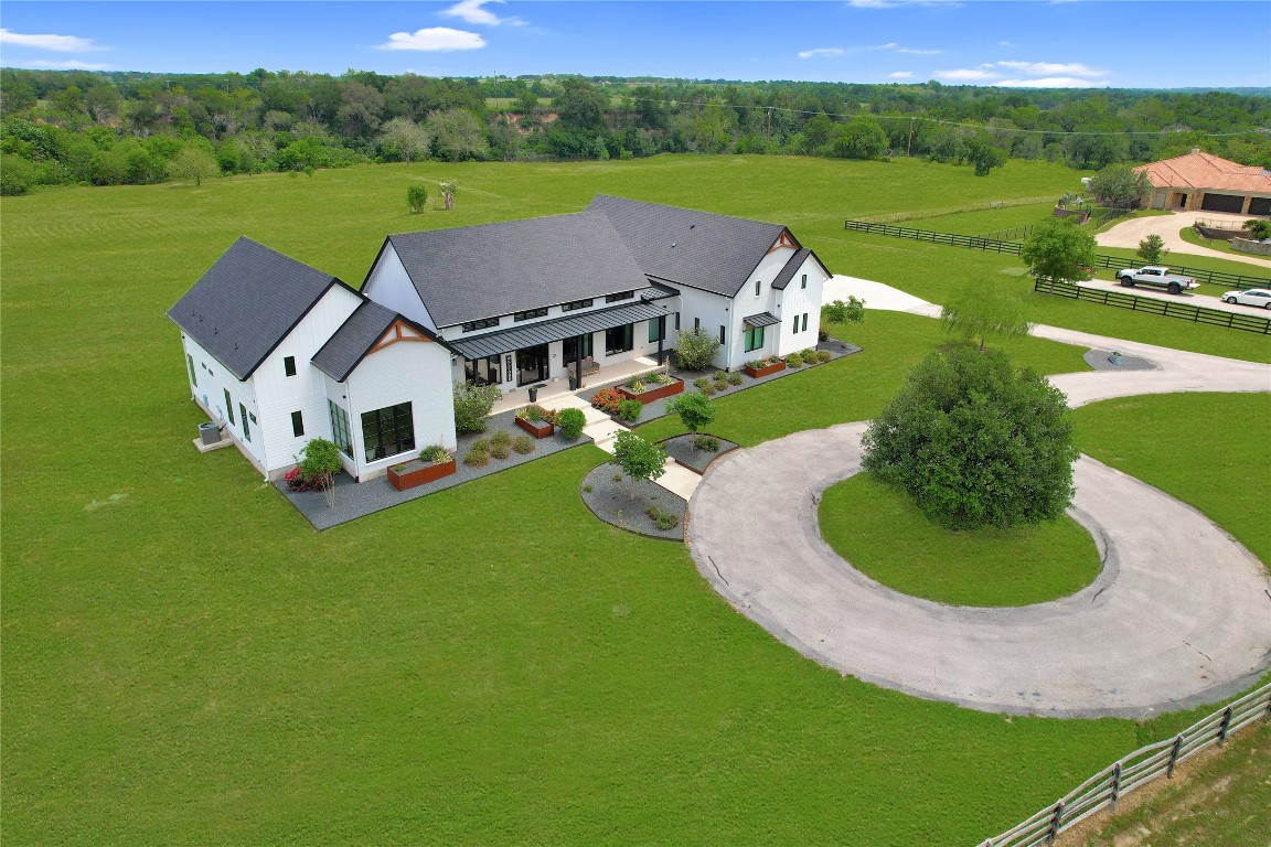 an aerial view of a house with outdoor space and street view