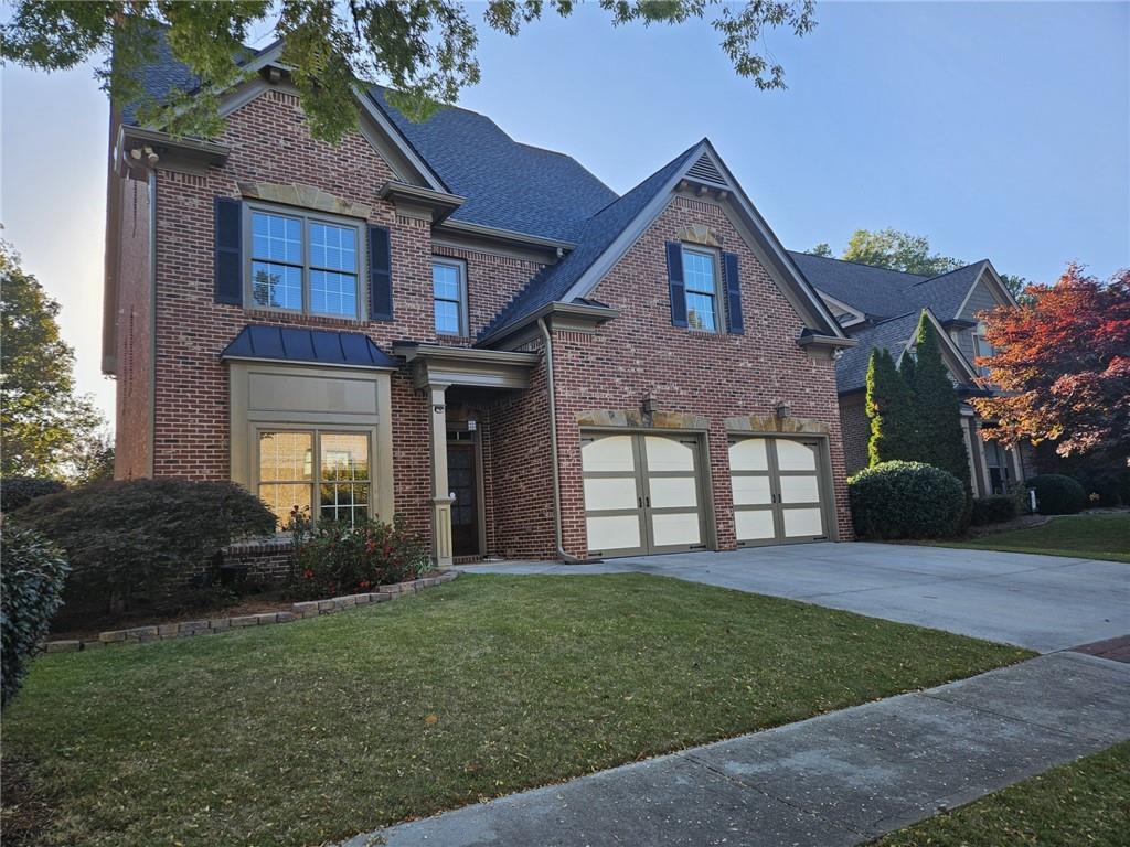 a front view of a house with a yard and garage