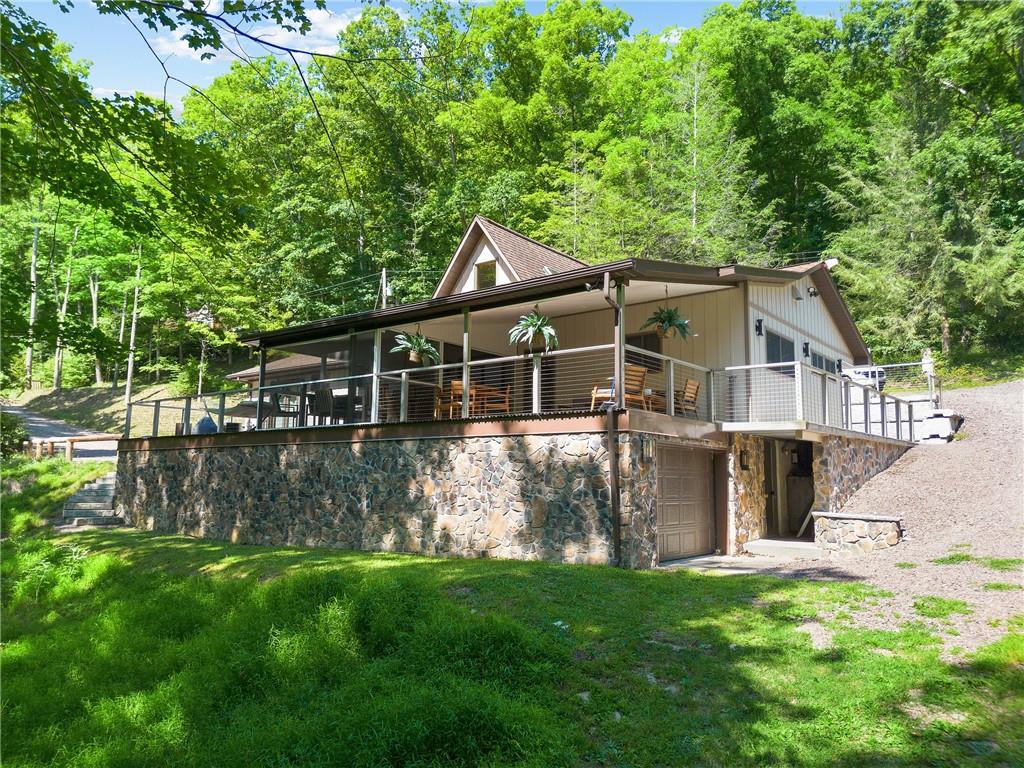 a front view of a house with a garden and yard