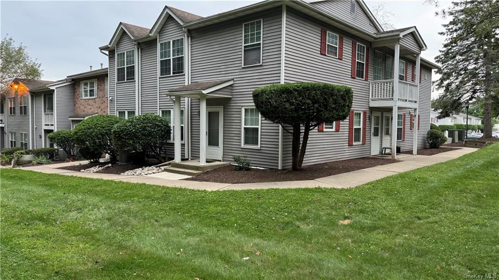 a front view of a house with yard and green space