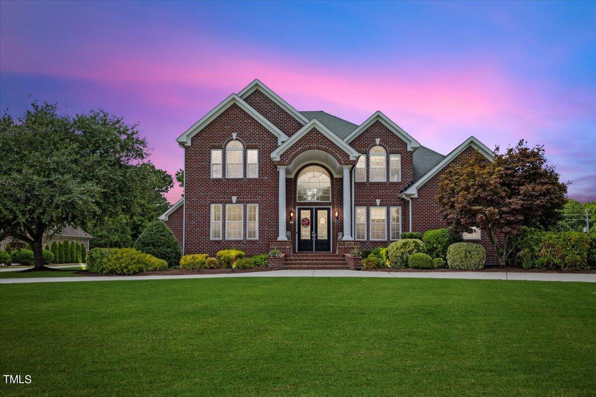 a front view of a house with a garden