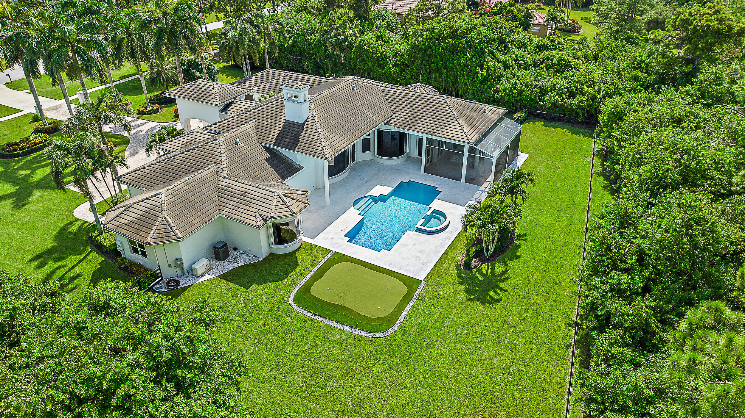 an aerial view of a house with pool patio and garden