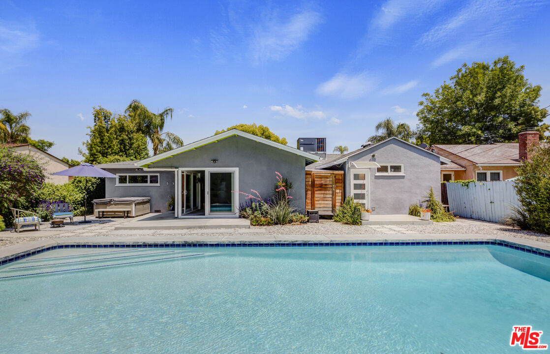 a front view of house with yard outdoor seating and barbeque oven