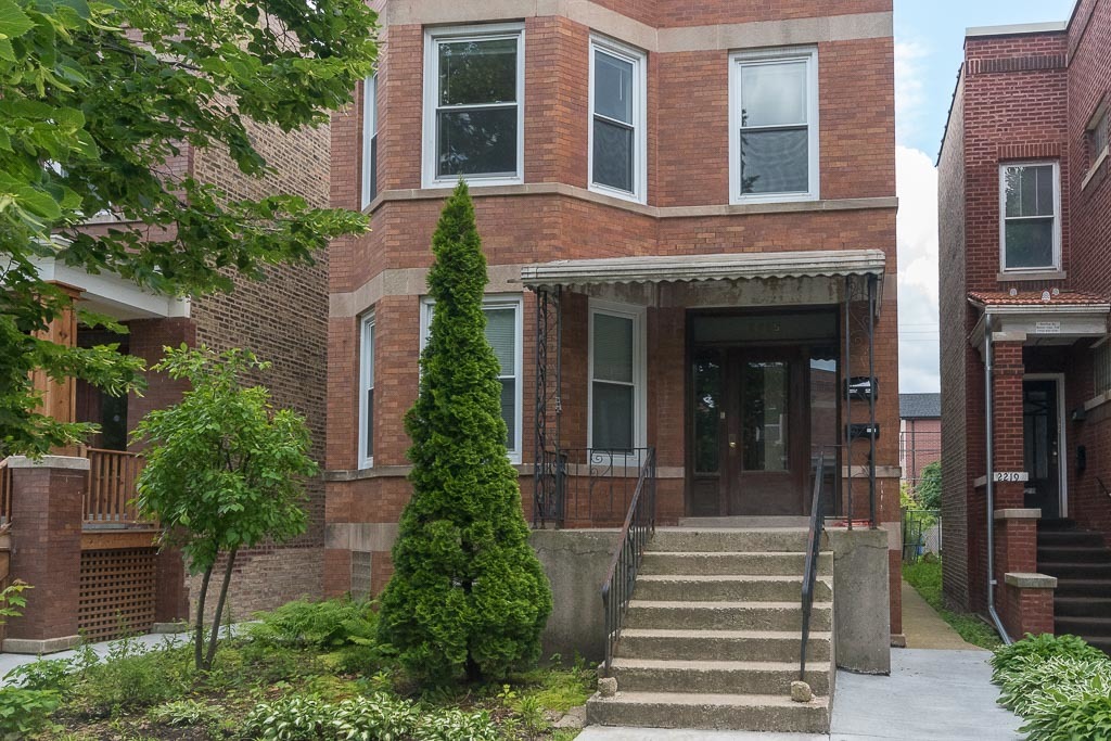 a front view of a house with a garden