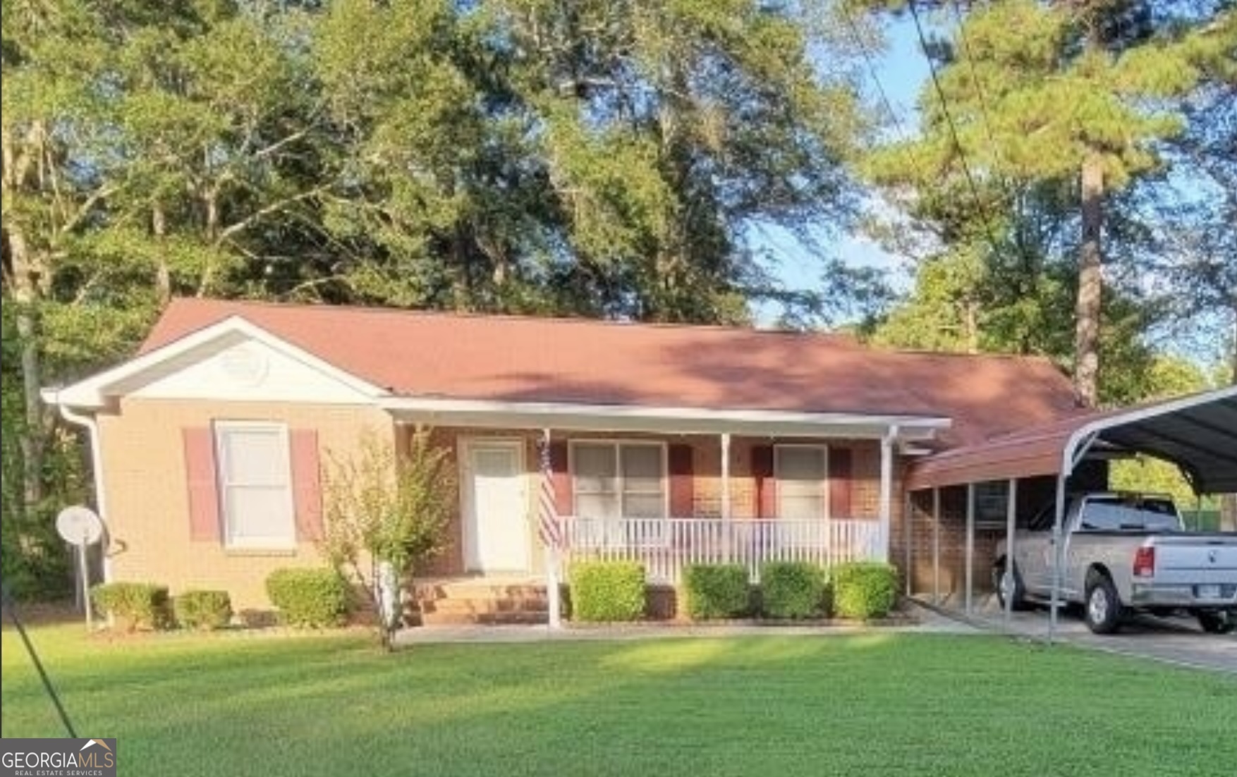 a front view of a house with a yard and trees