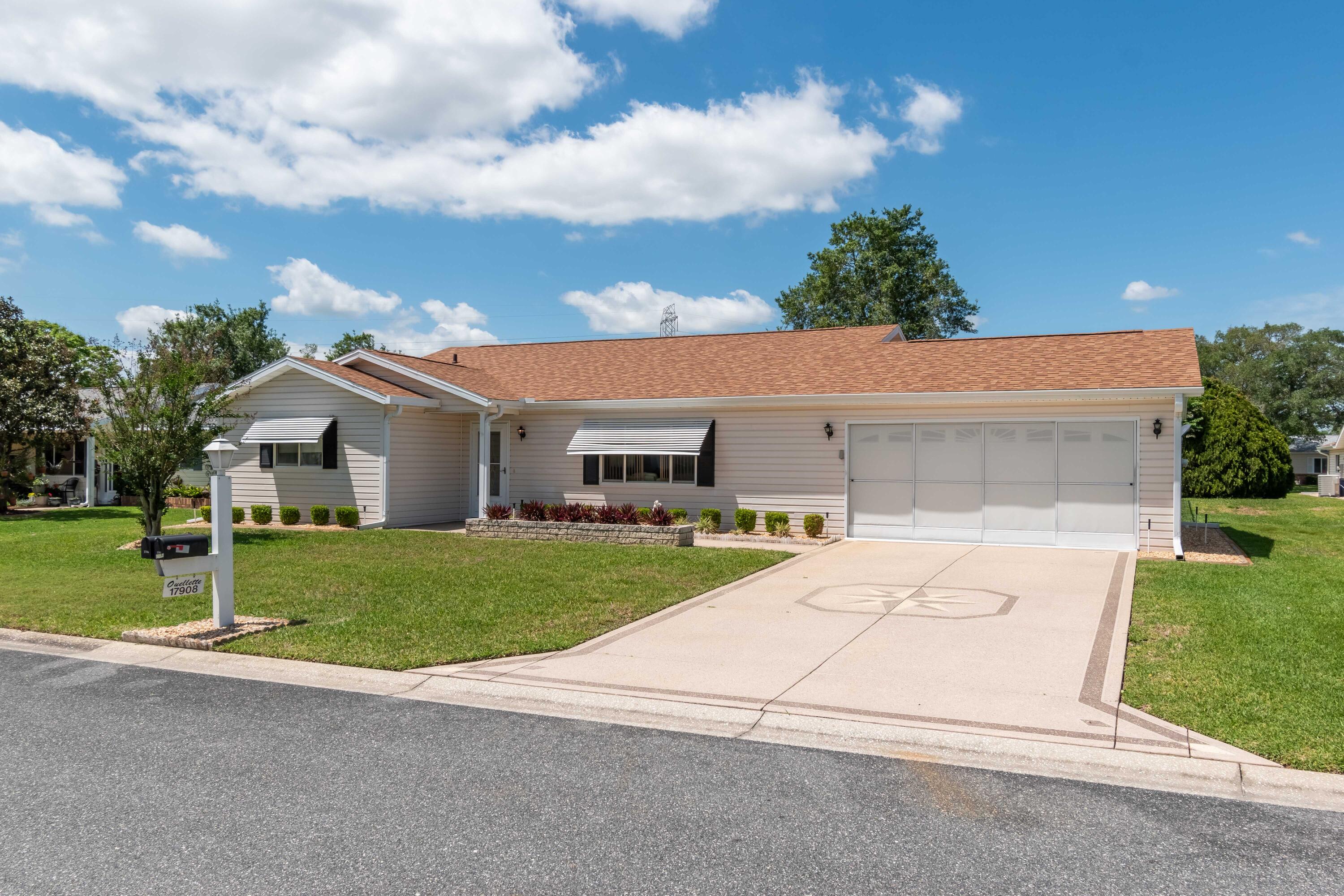 a aerial view of a house with a yard and garage