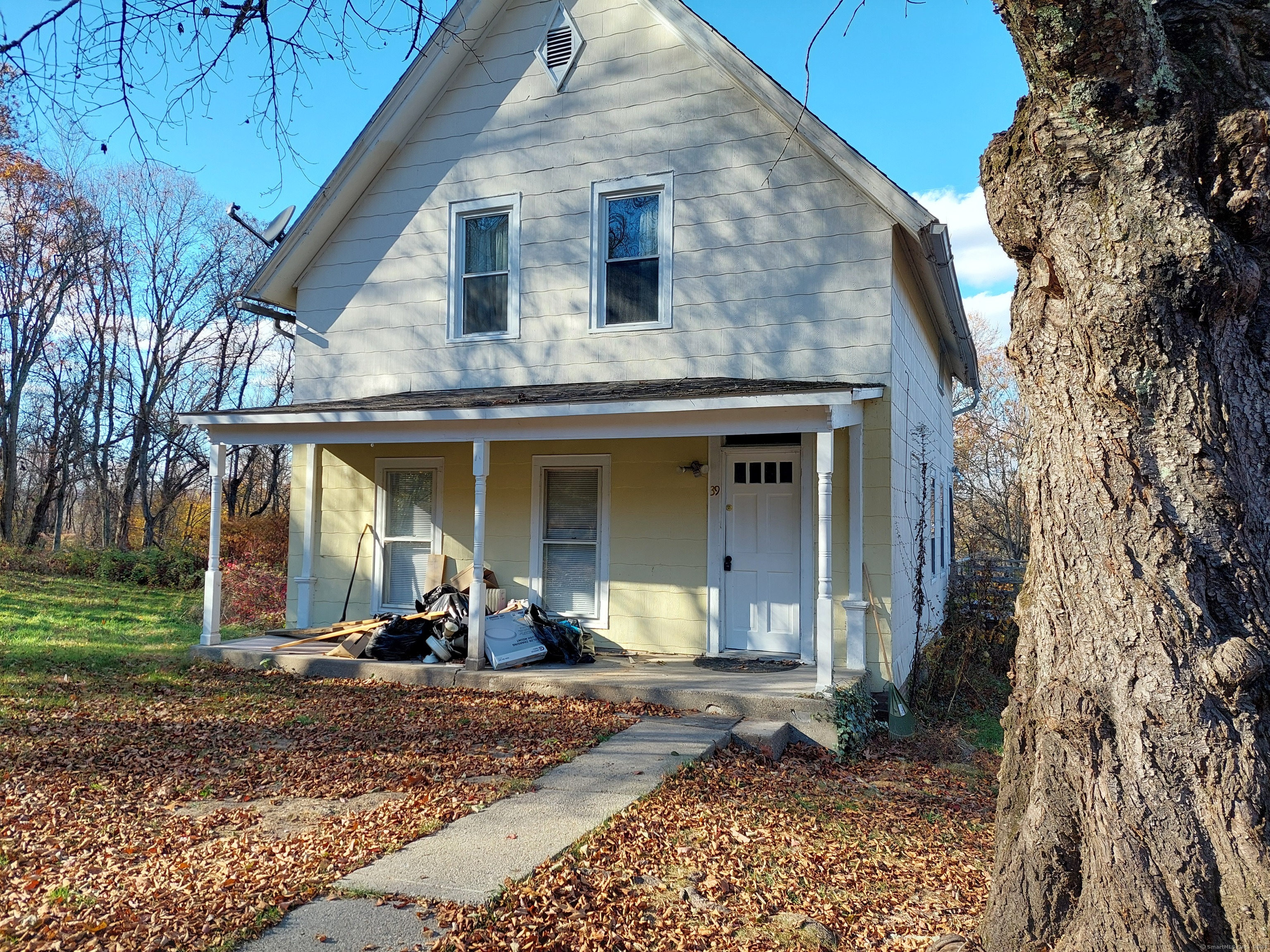 a front view of a house with lots of furniture and garden