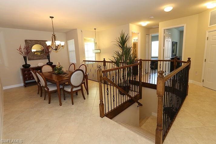 an entryway with dining room and chandelier