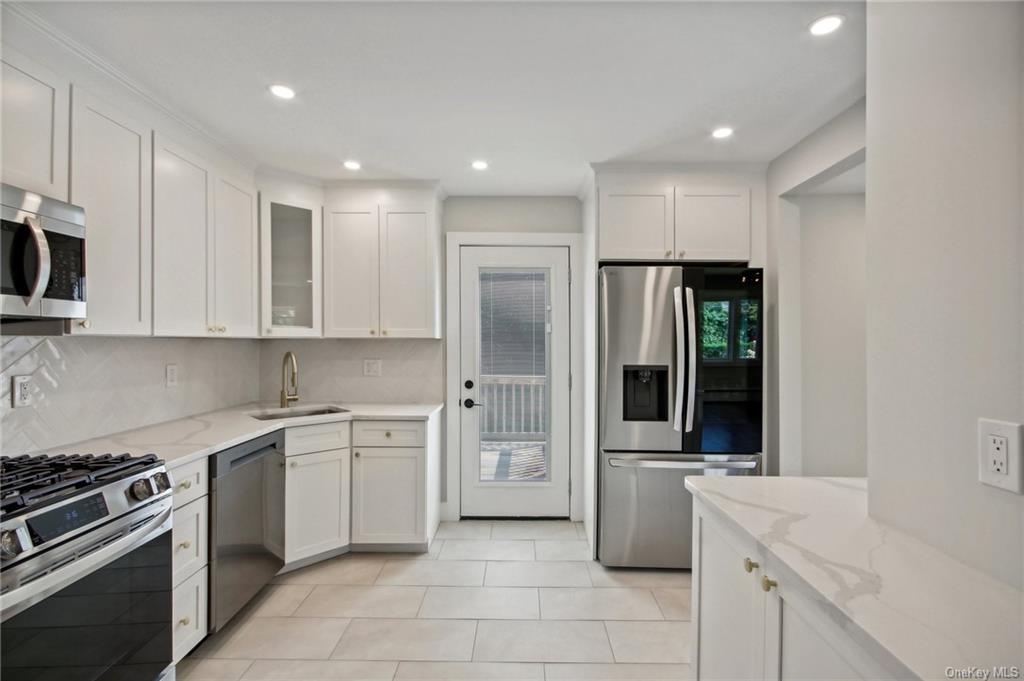 a kitchen with a sink stove and refrigerator