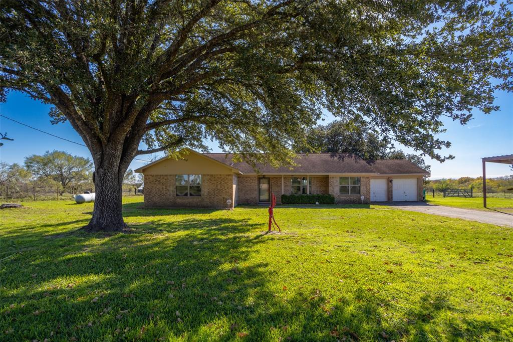 a house with huge green field in front of it