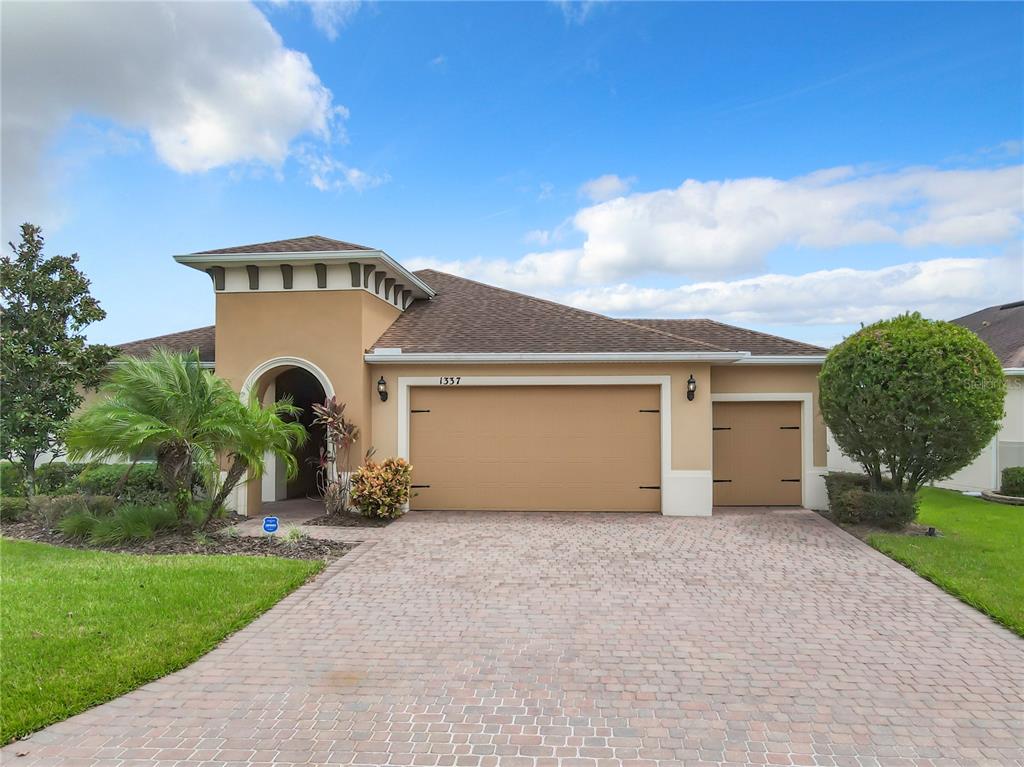 a front view of a house with a yard and garage