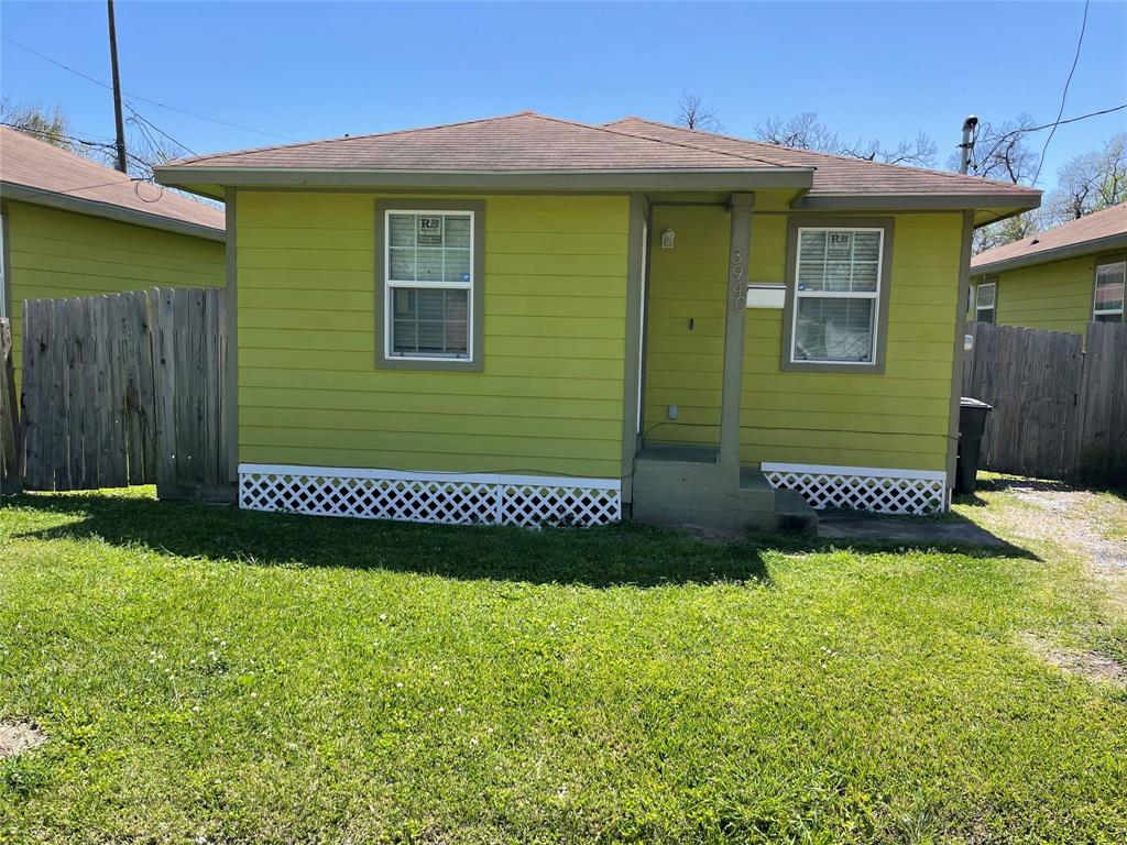 a view of a house with a small yard