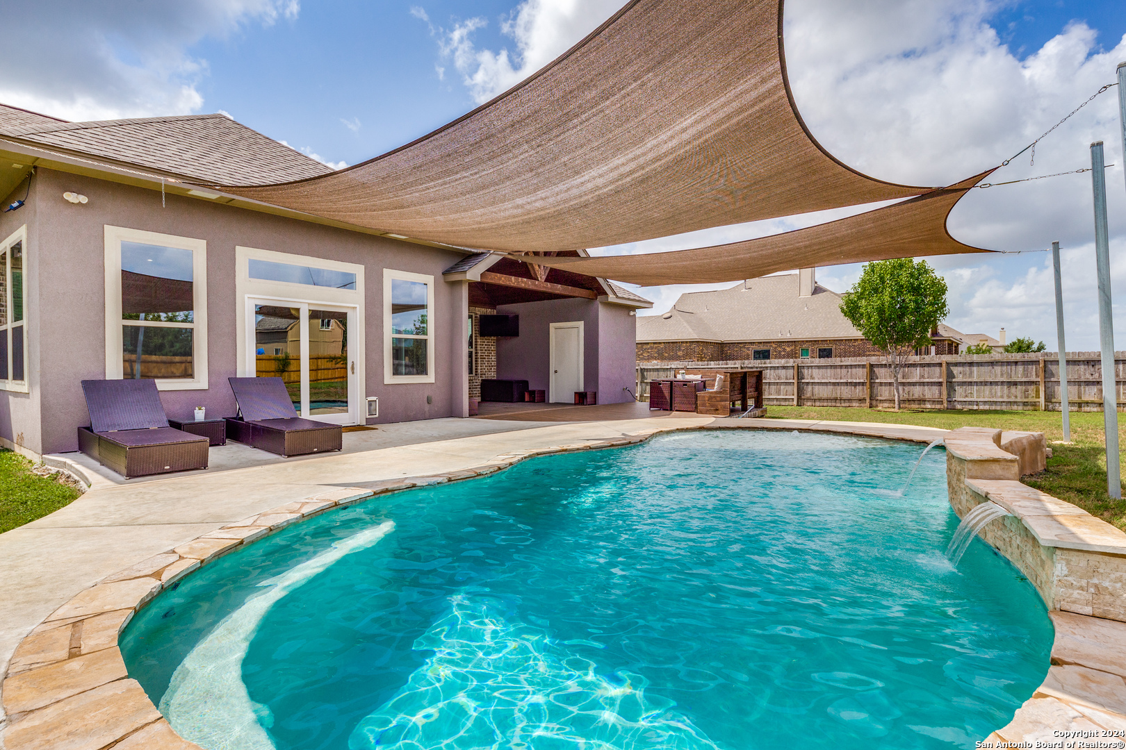 a swimming pool with outdoor seating yard and barbeque oven