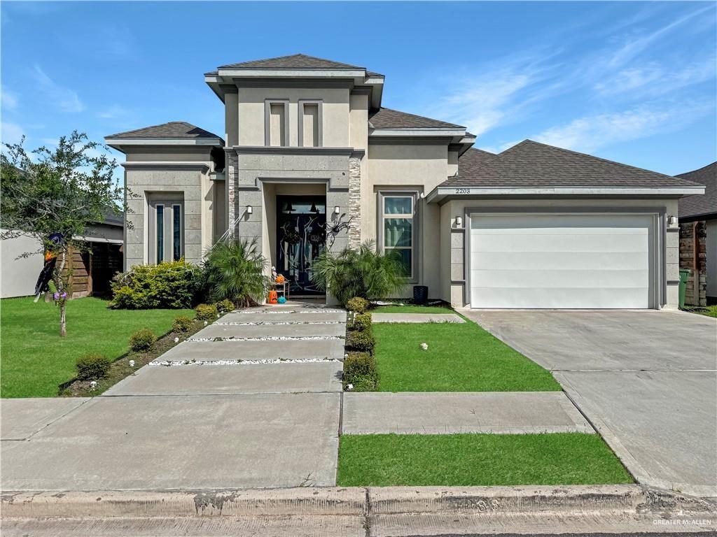 a front view of a house with garden