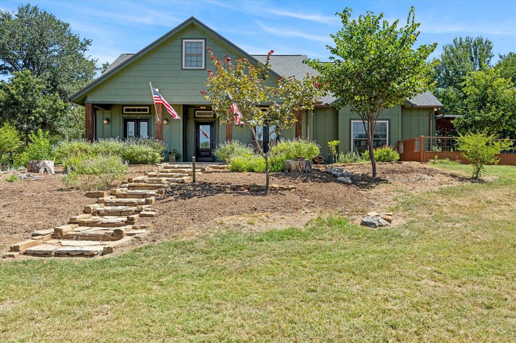 a front view of a house with a garden