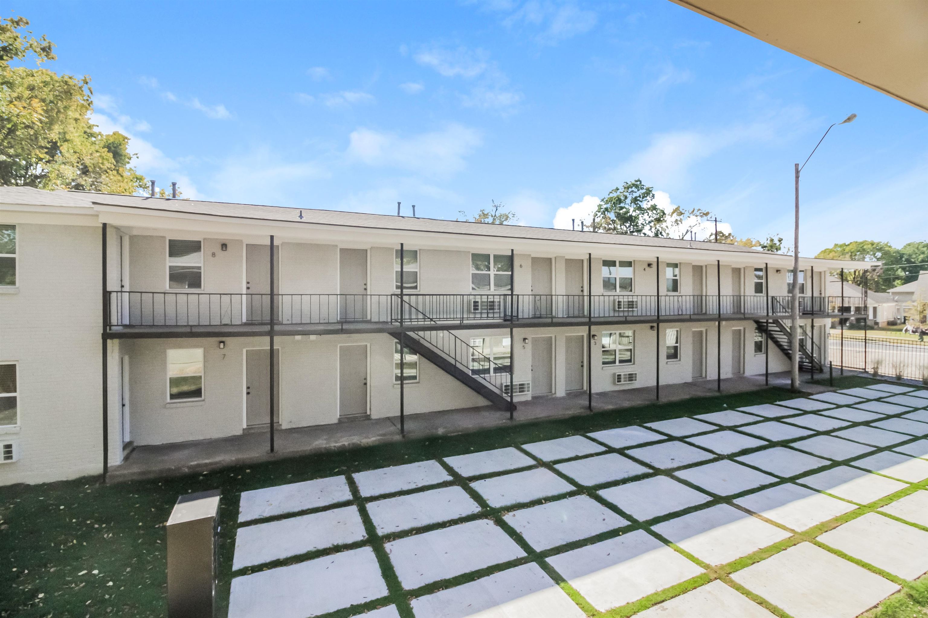 a view of a balcony with wooden floor and fence