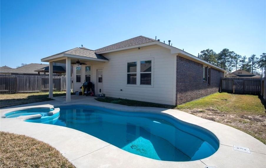 a view of a house with swimming pool in front of it