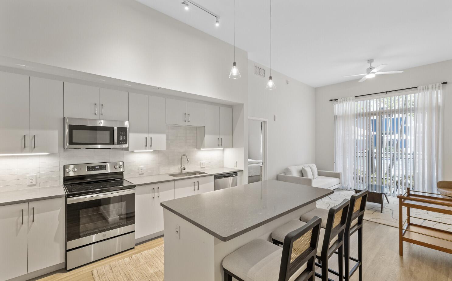 a kitchen with a stove a sink and a refrigerator