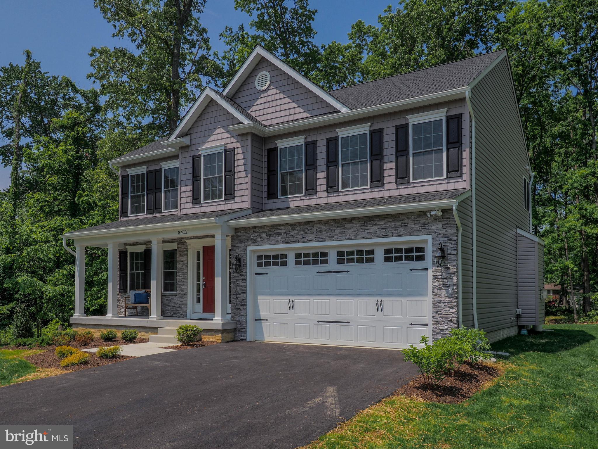 a front view of a house with a yard and a garage