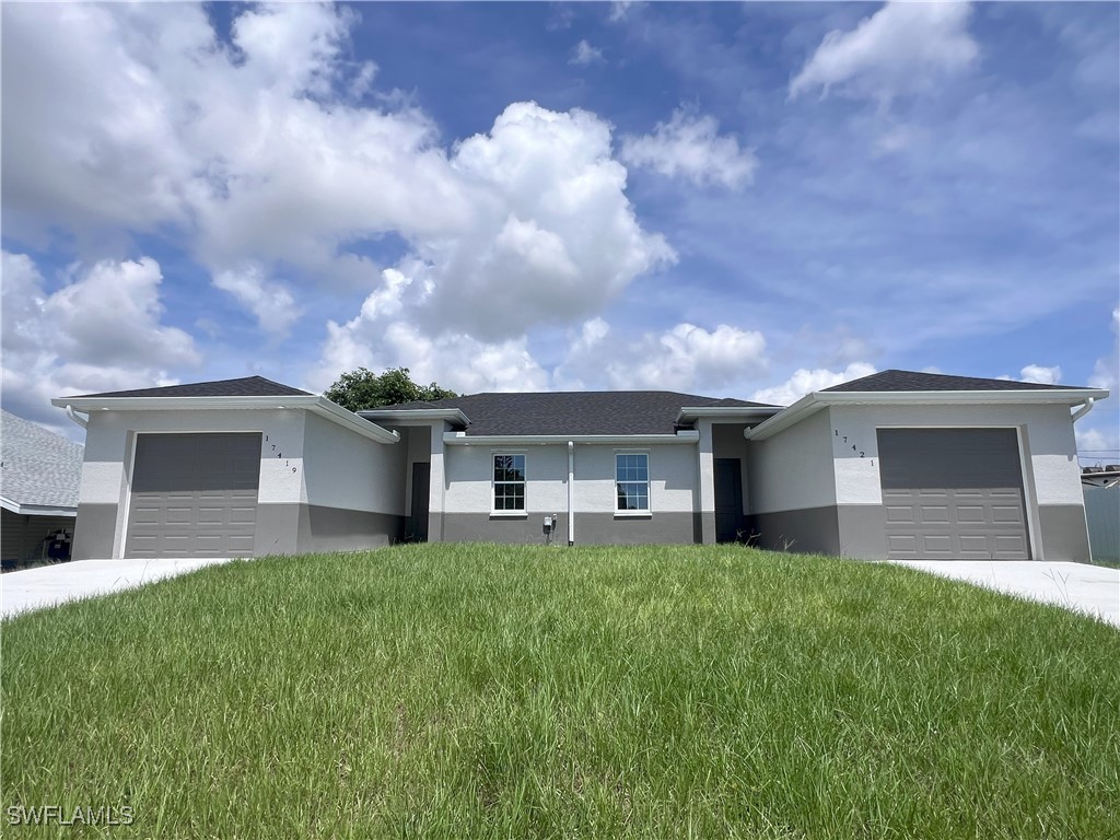 a front view of a house with yard and green space