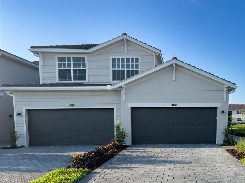 a front view of a house with garage