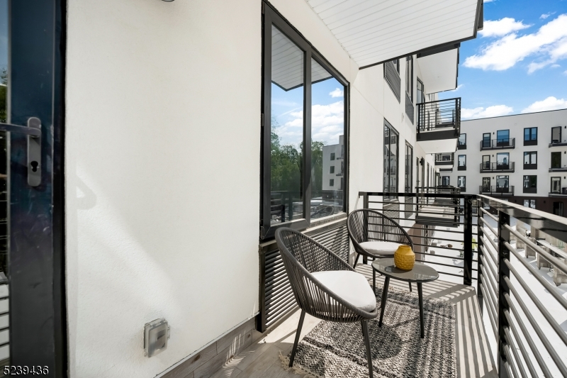 a view of a chairs and table in a balcony